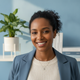 Headshot portrait of a happy, diverse woman smiling, implying satisfaction and well-being.
